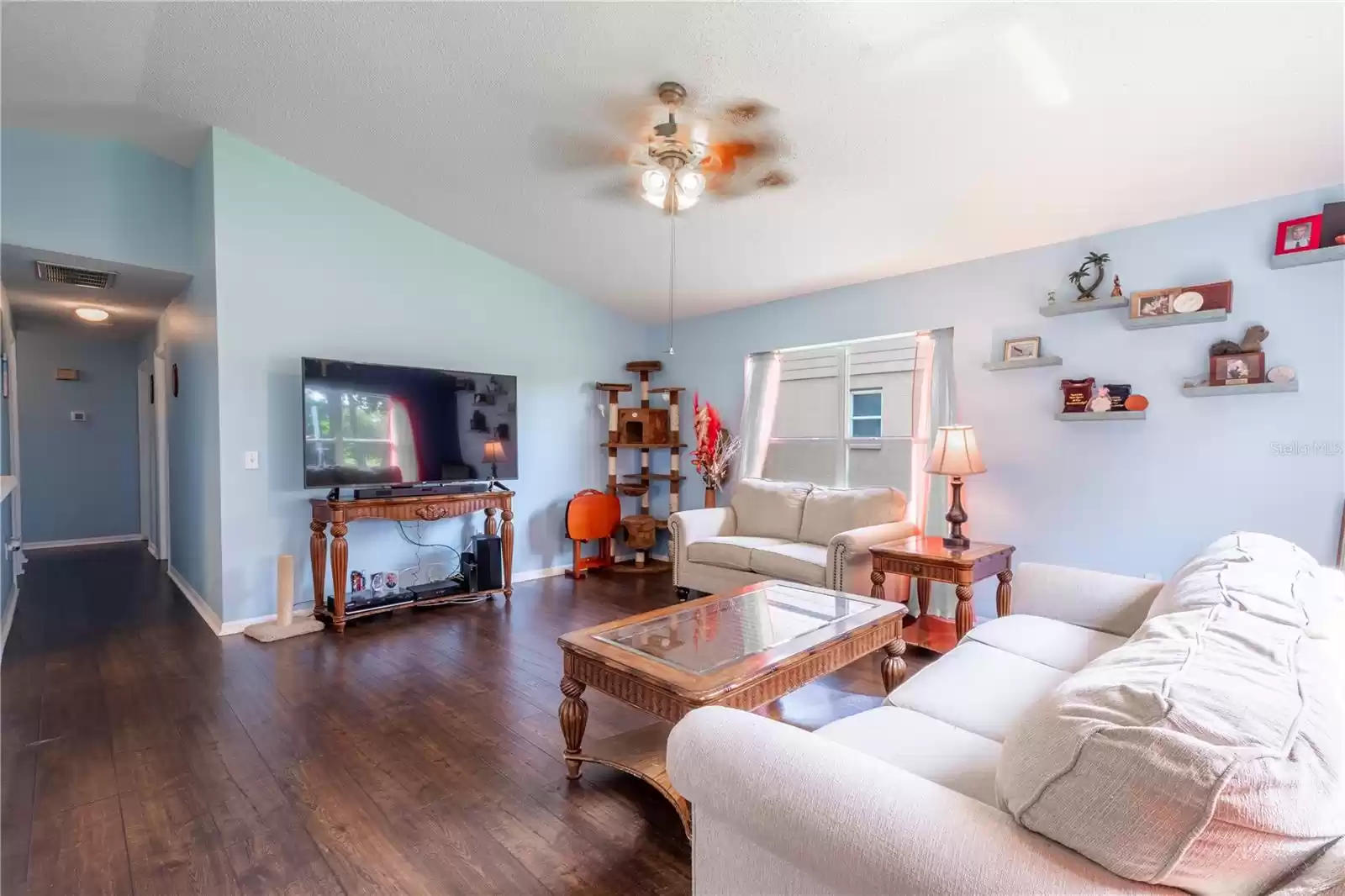 The family room features a ceiling fan with light kit.