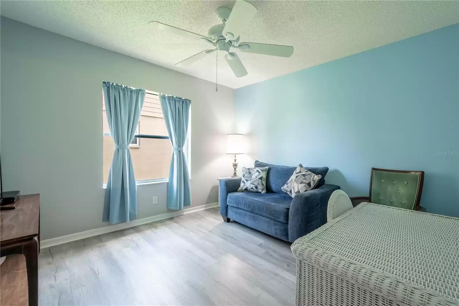 2nd bedroom features luxury vinyl flooring, a built in closet and a ceiling fan.