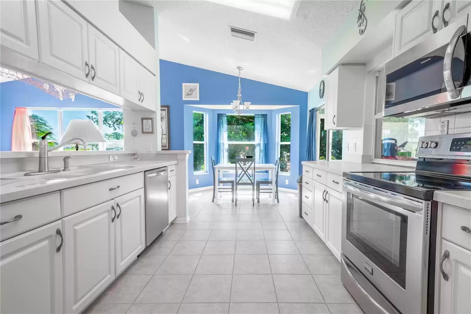 The galley kitchen features a suite of stainless steel appliances.