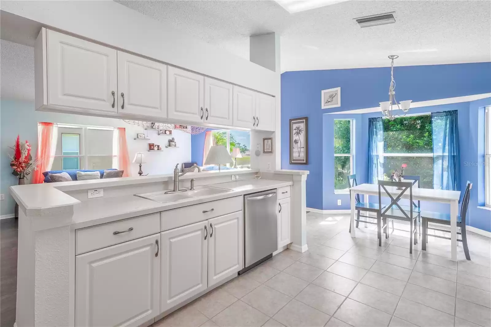 The kitchen features ceramic tile flooring and overhead lighting.