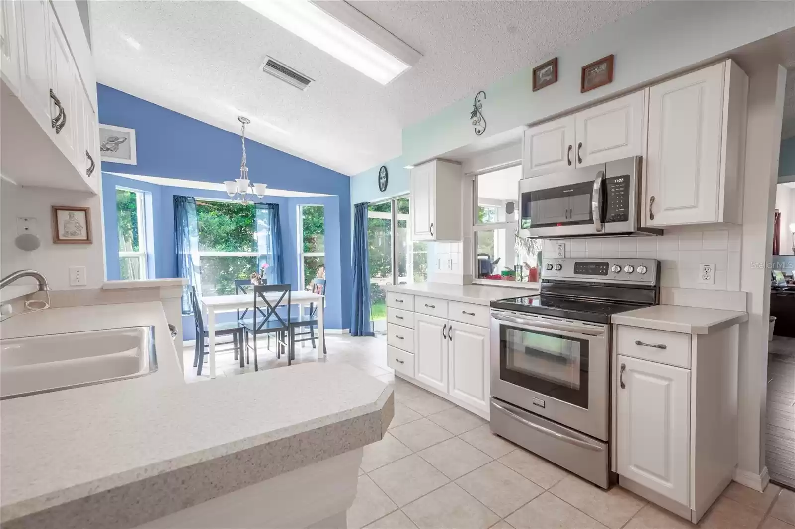 The kitchen features neutral tone corian counters.