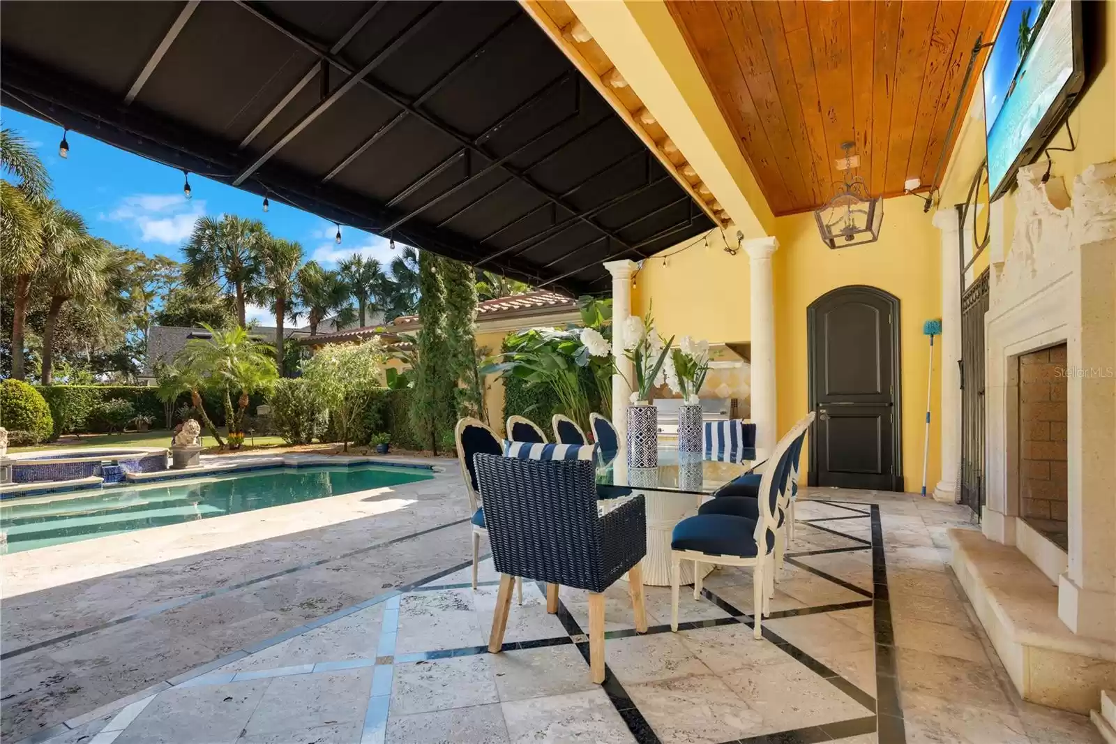 Covered Outdoor Dining with Dutch Door to Pool Bath, Catering Room & Garage