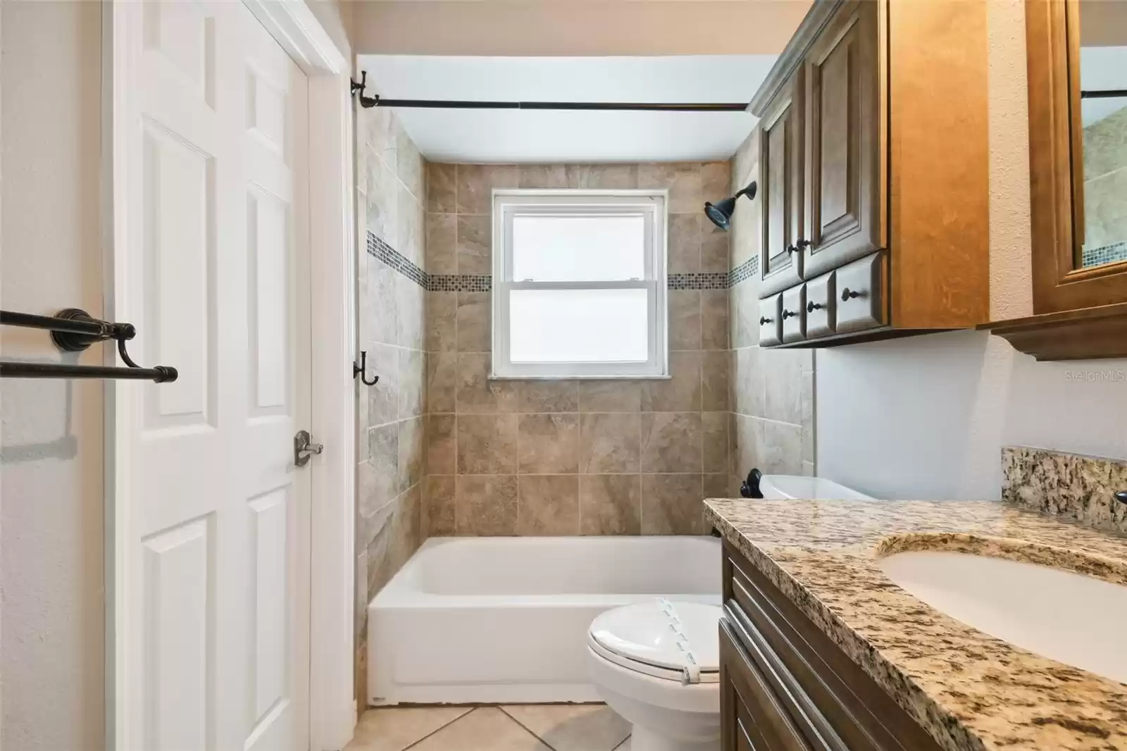 Upstairs full bathroom connected to bedroom with hallway access