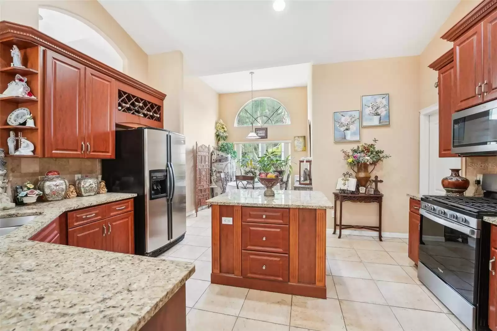 Kitchen with wine rack, appliances and island