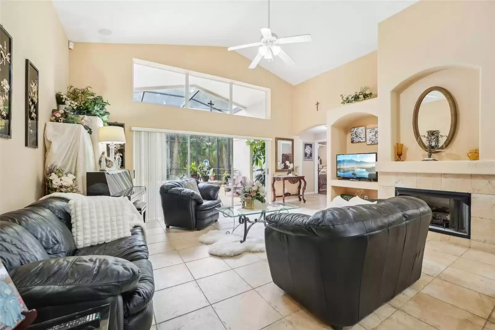 Family room with view of gas fireplace and view of pool area