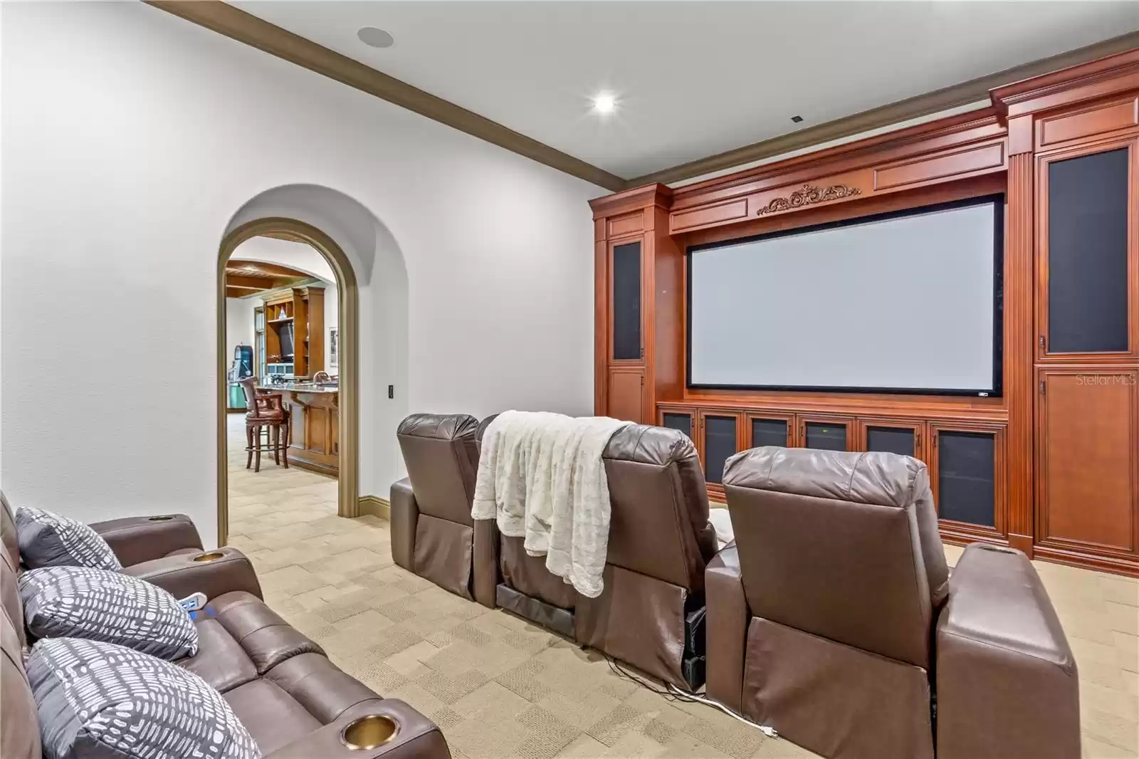 Home Theater is a classic style tucked away on the main floor  with two entry doorways