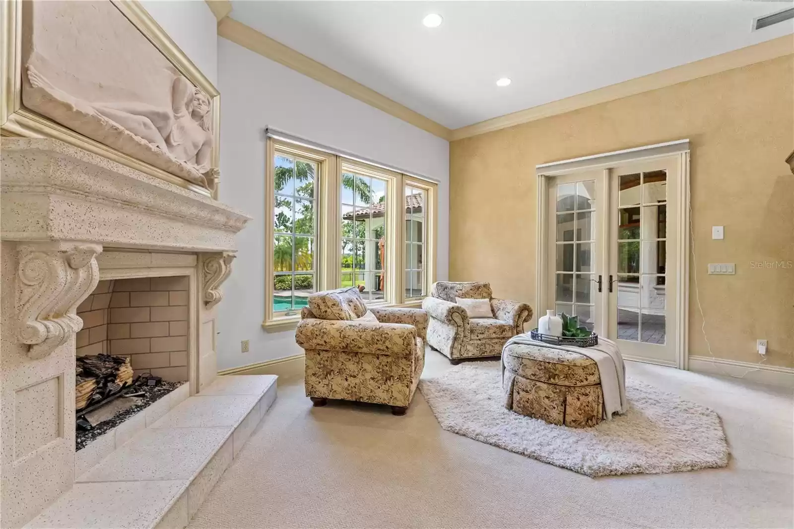 Primary Retreat enjoys a gorgeous fireplace, and views of the pool and 2 acre back yard