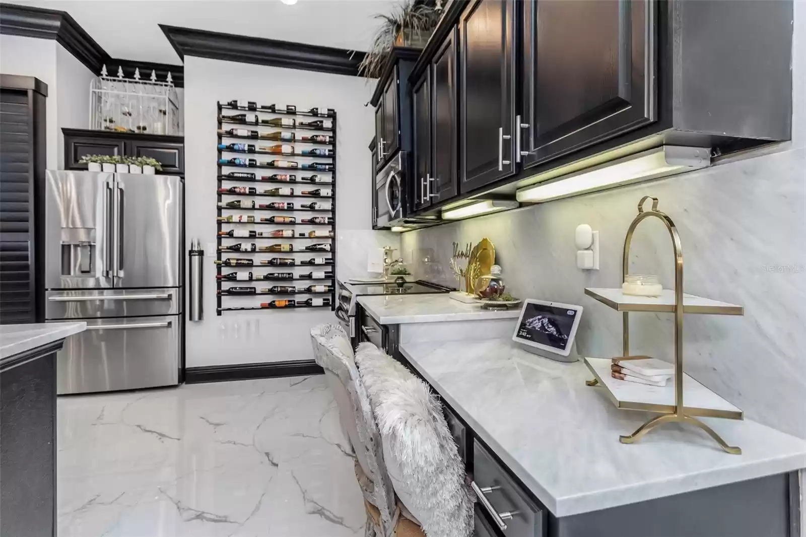 view into the kitchen showing working desk with marble counter and backsplash