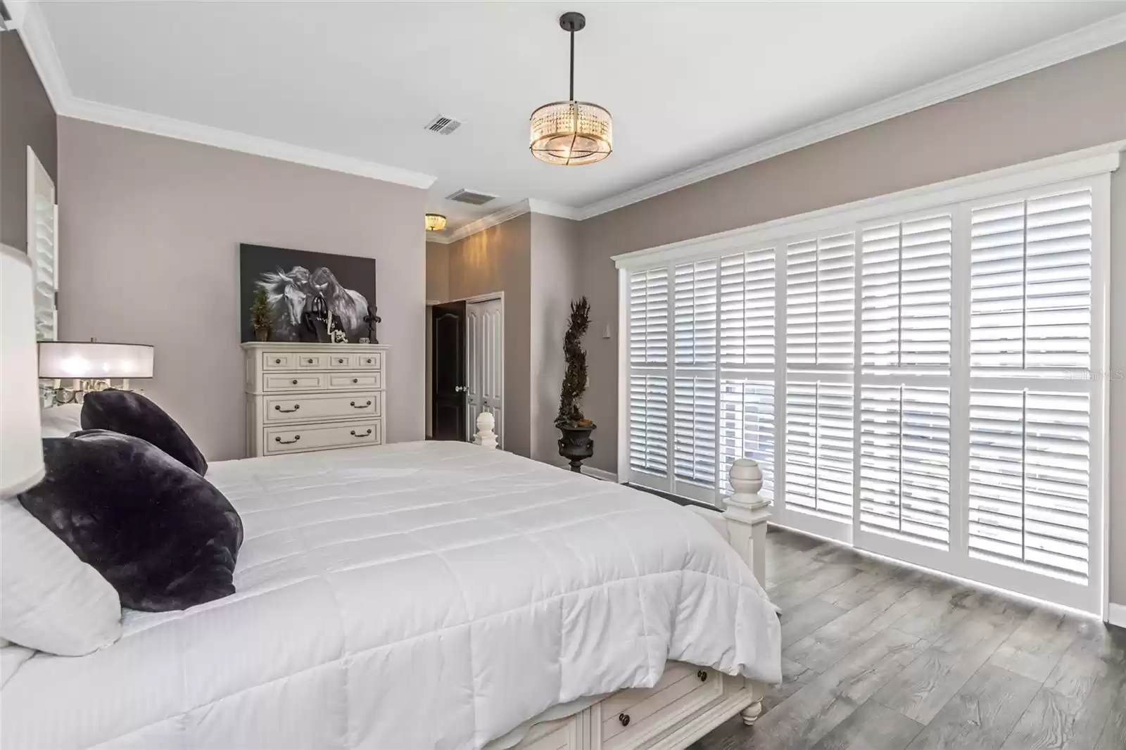 View in primary bedroom showing the wall of sliding doors that open on the lanai where your Spa and pool await your relaxing pleasure