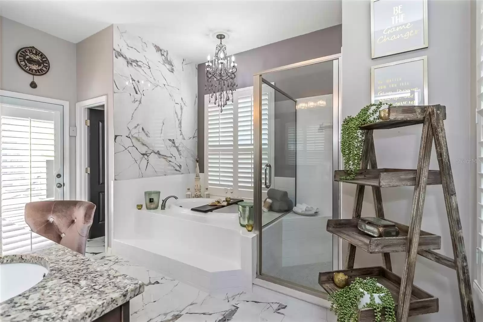 Primary bathroom featuring garden tub with polished porcelain wall and separate walk-in shower