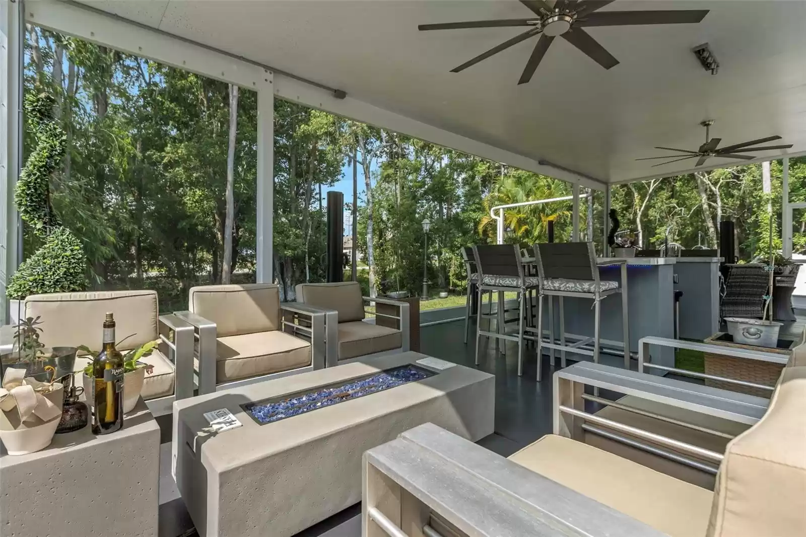 Notice the wooded views from the covered lanai. Your complete privacy can be enjoyed on the lanai by employing the horizonal installed retractable 6' high privacy screens.