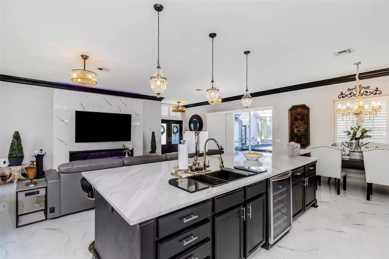 View from the kitchen showing beautiful wide marble counter, black stainless sink, pull-down faucet, for preparing, dining and entertaining