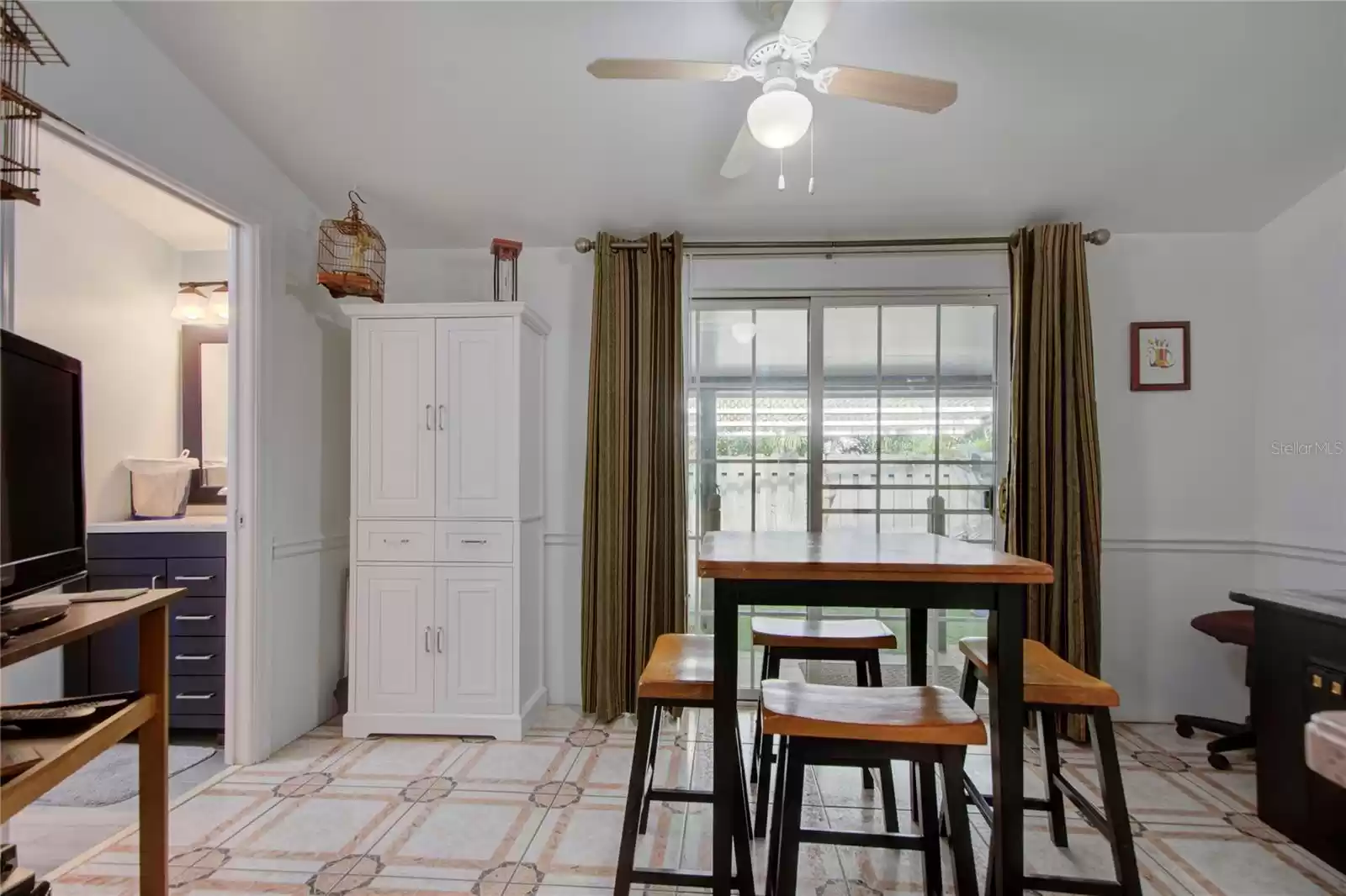 dining room looking out patio door to side deck and hammock area