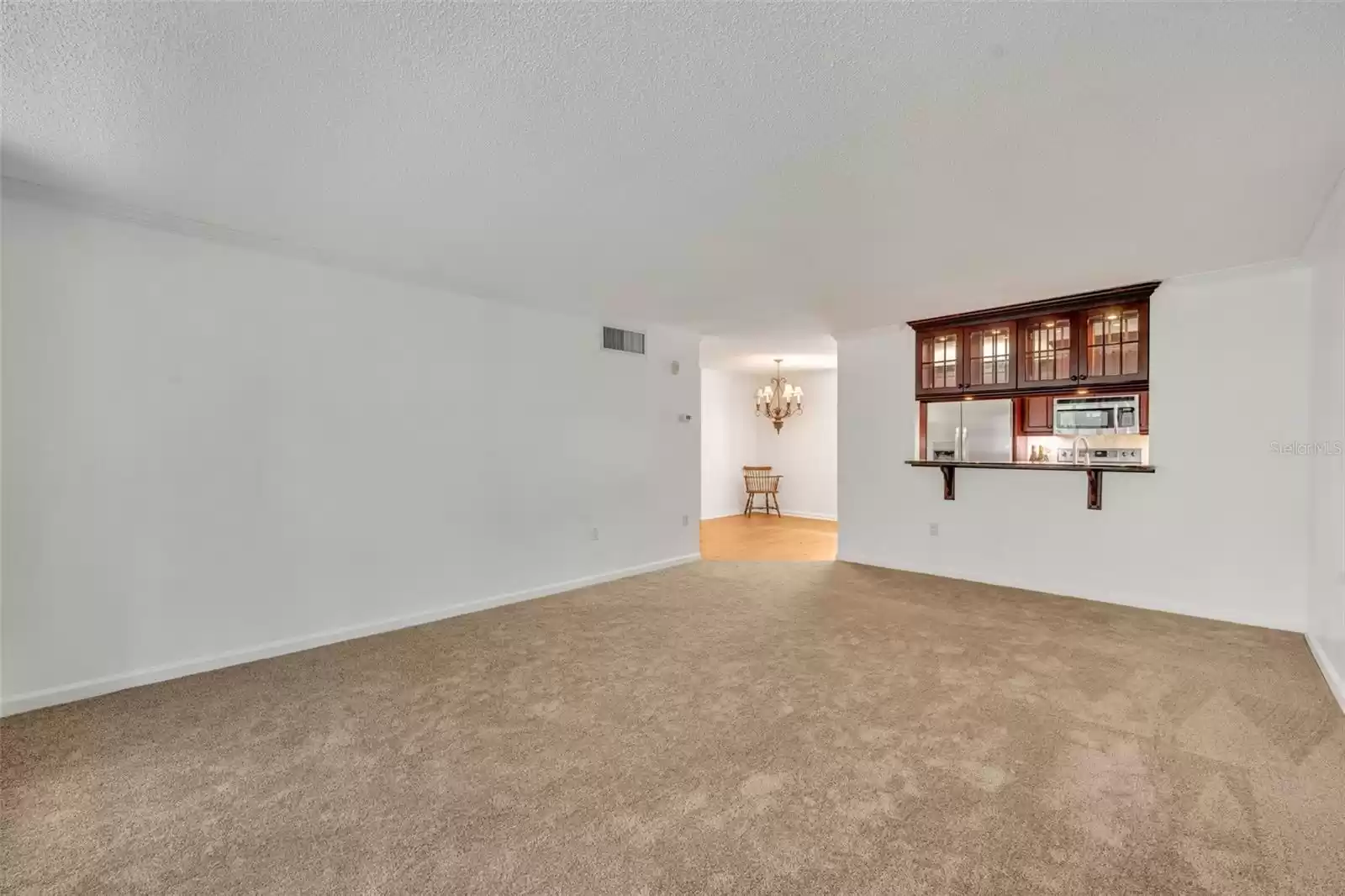 Living Room towards kitchen with pretty glass cabinets