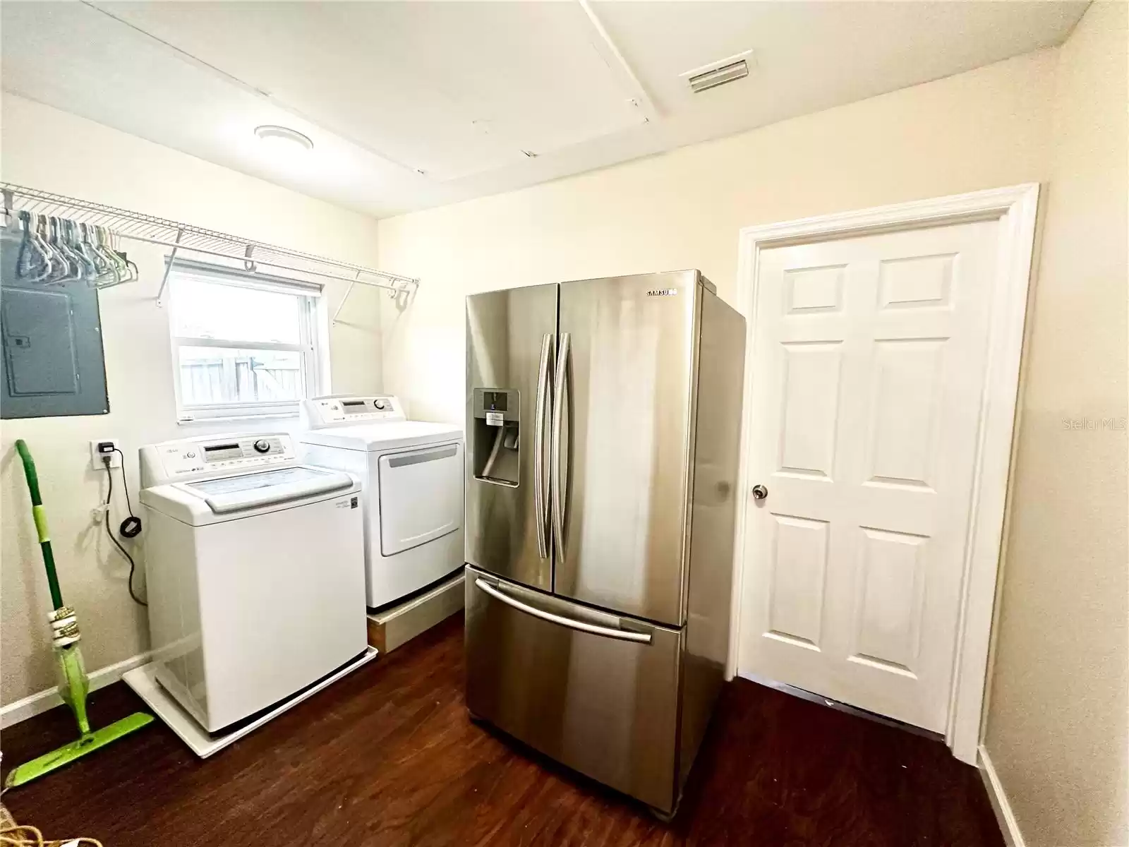 Laundry room with second fridge