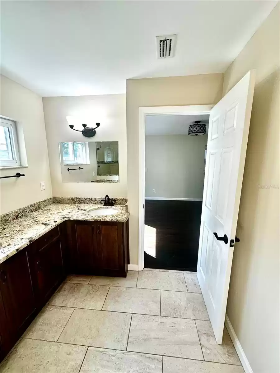 Primary Bathroom with granite countertops