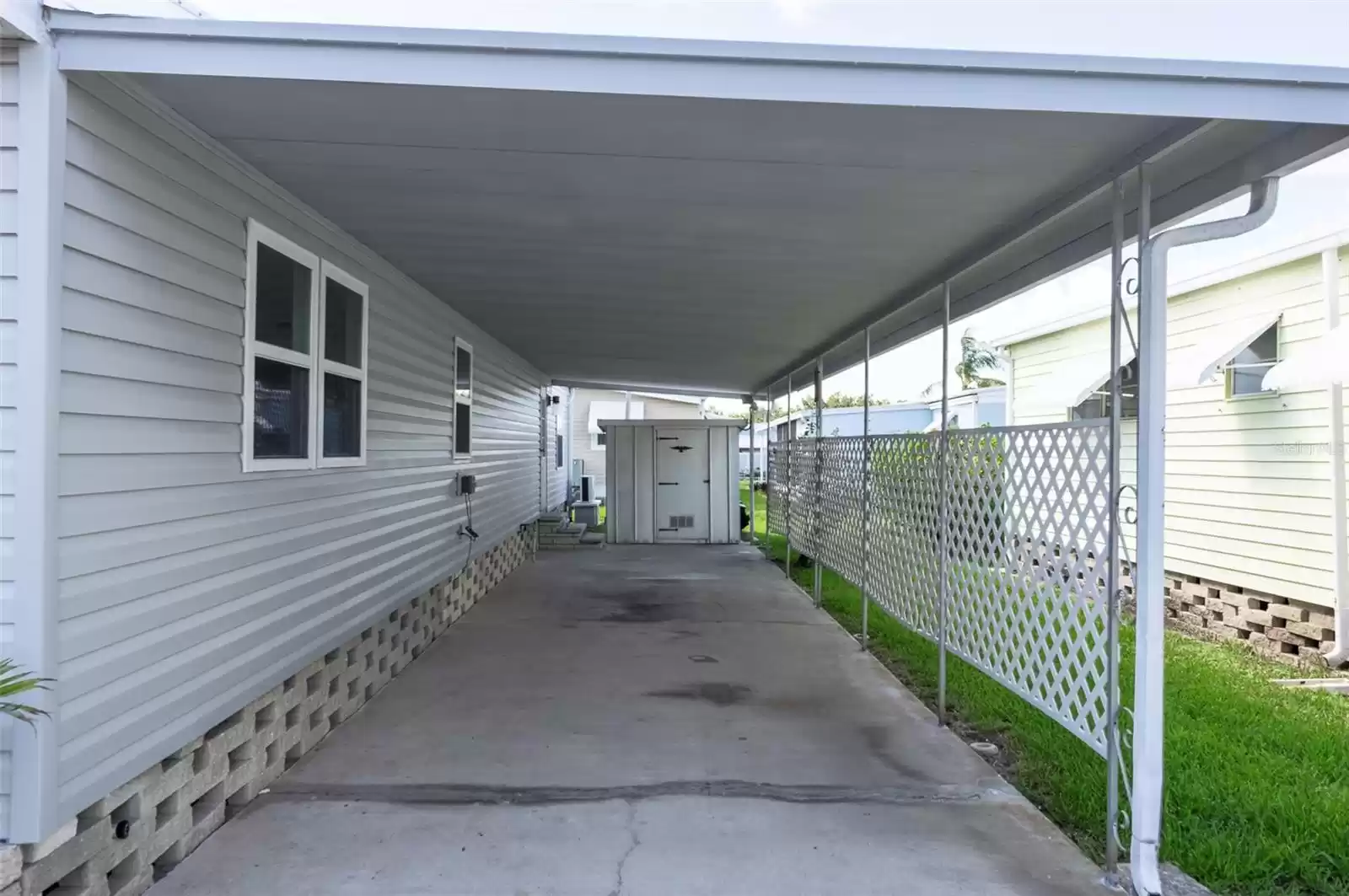 Covered Carport with storage shed.