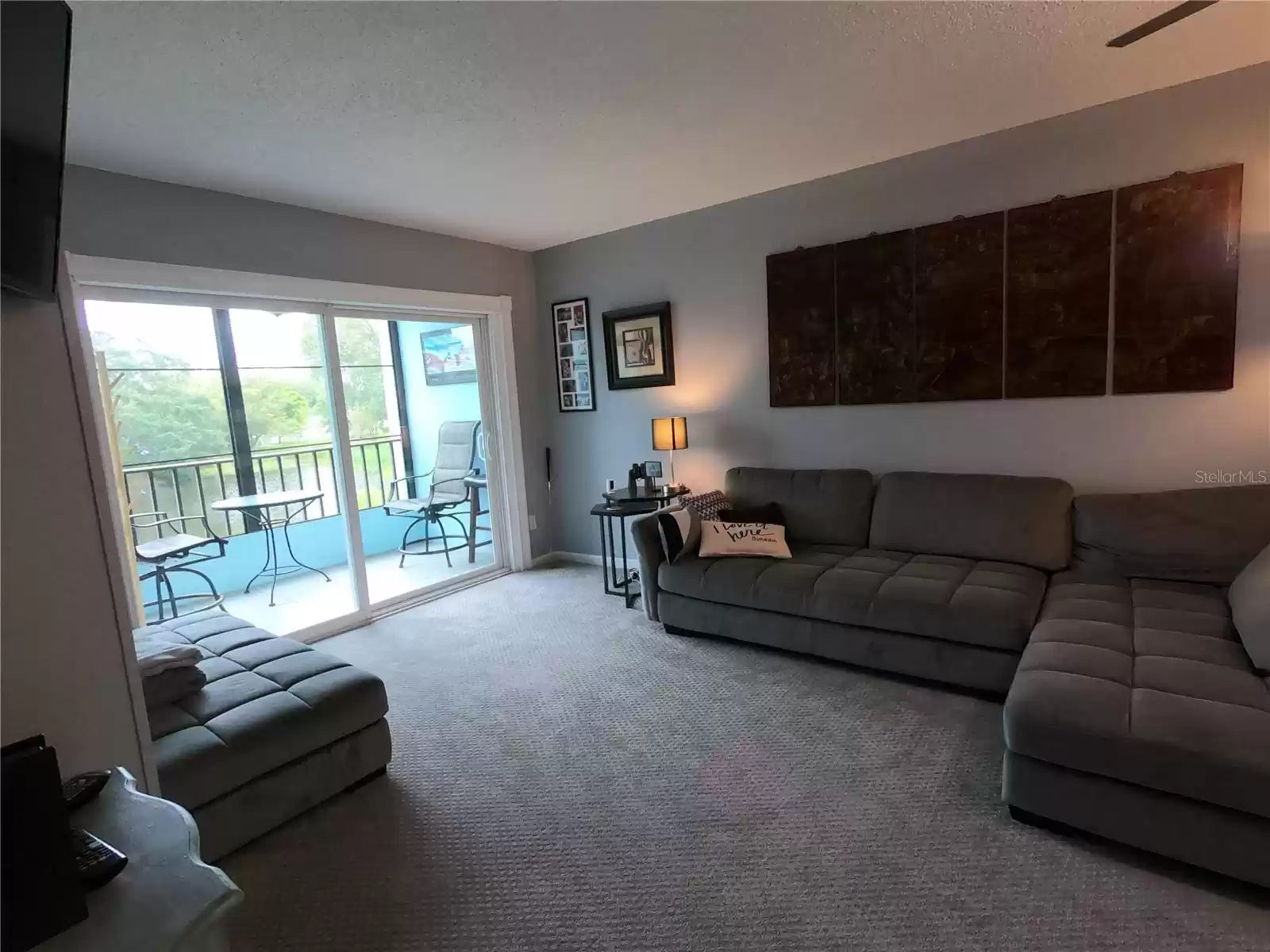 Living room with balcony and view of pond