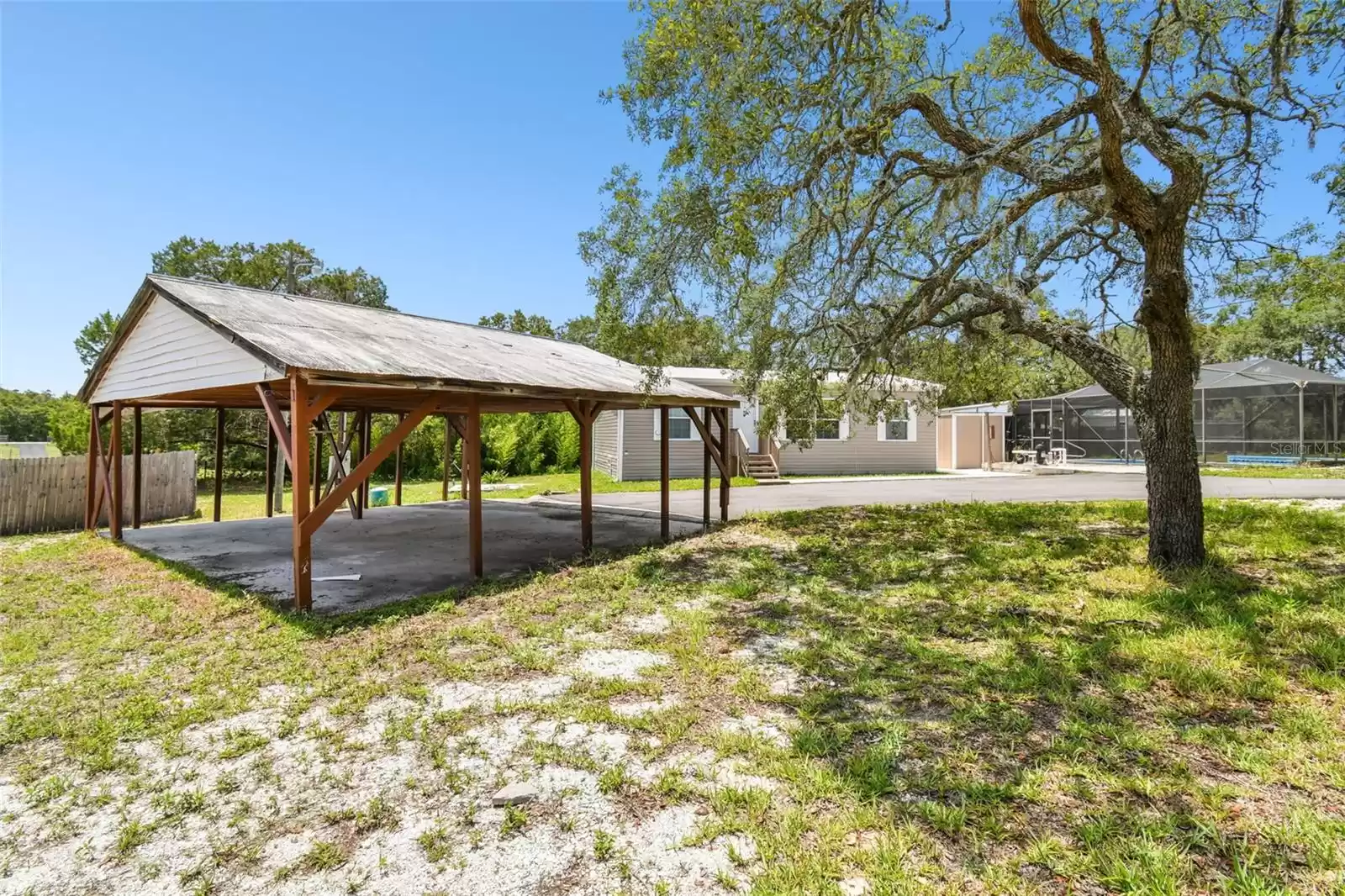 Large Wooden Covered Area for 2.5 Cars or anything you want to make it. Has space above for storage.