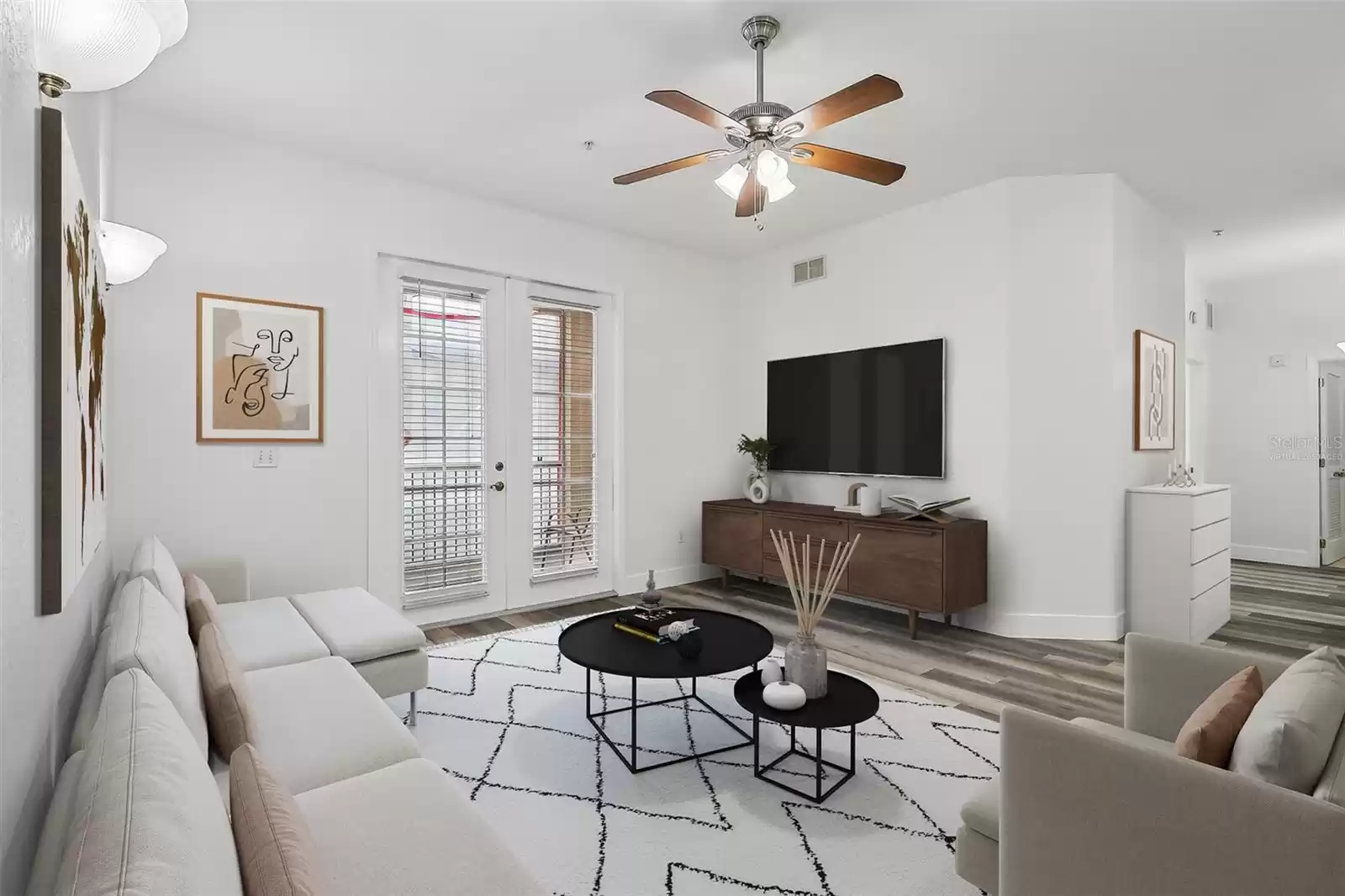 Living room with French doors to balcony. Virtually Staged.