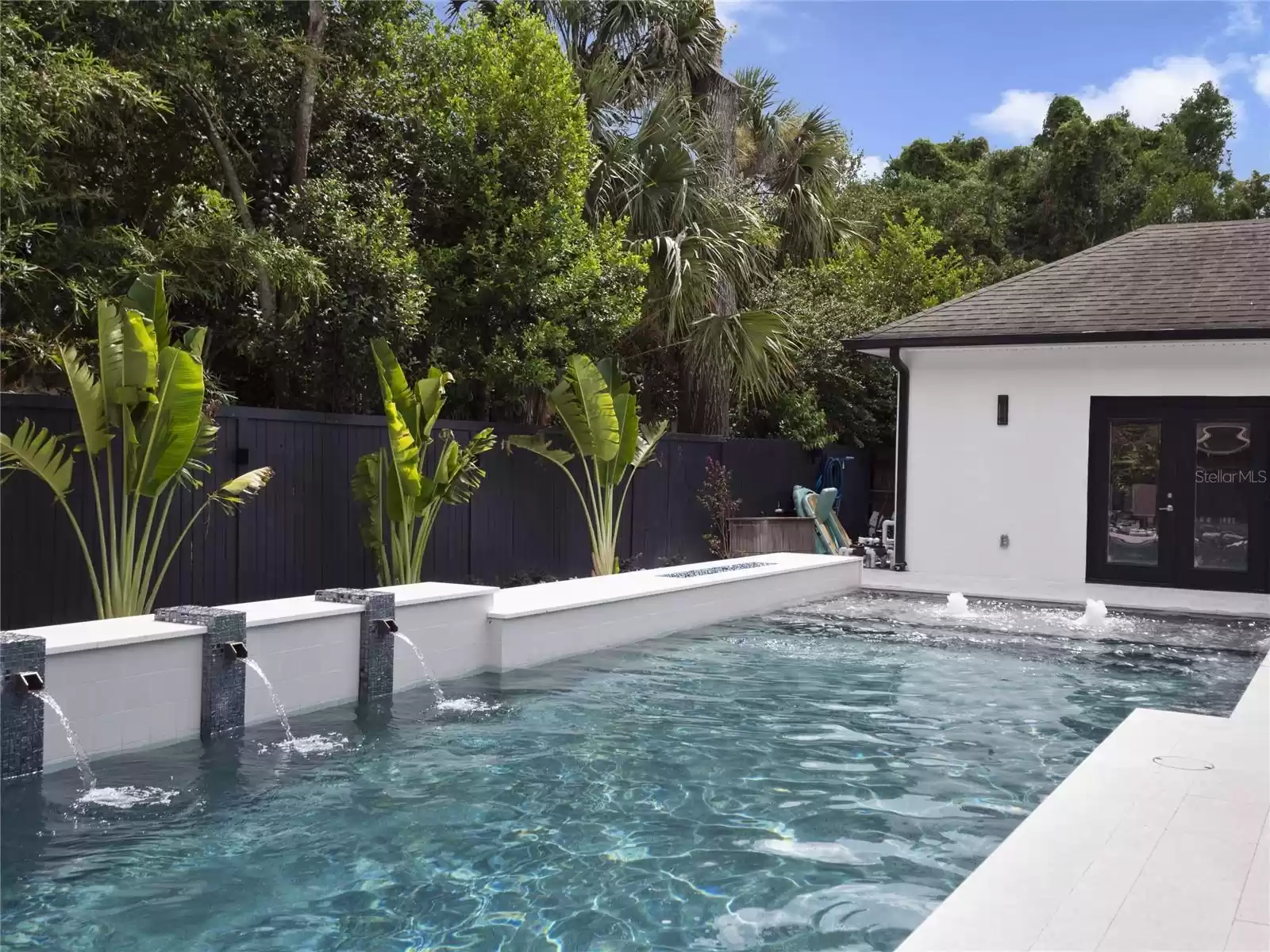 Pool looking to the detached media room.