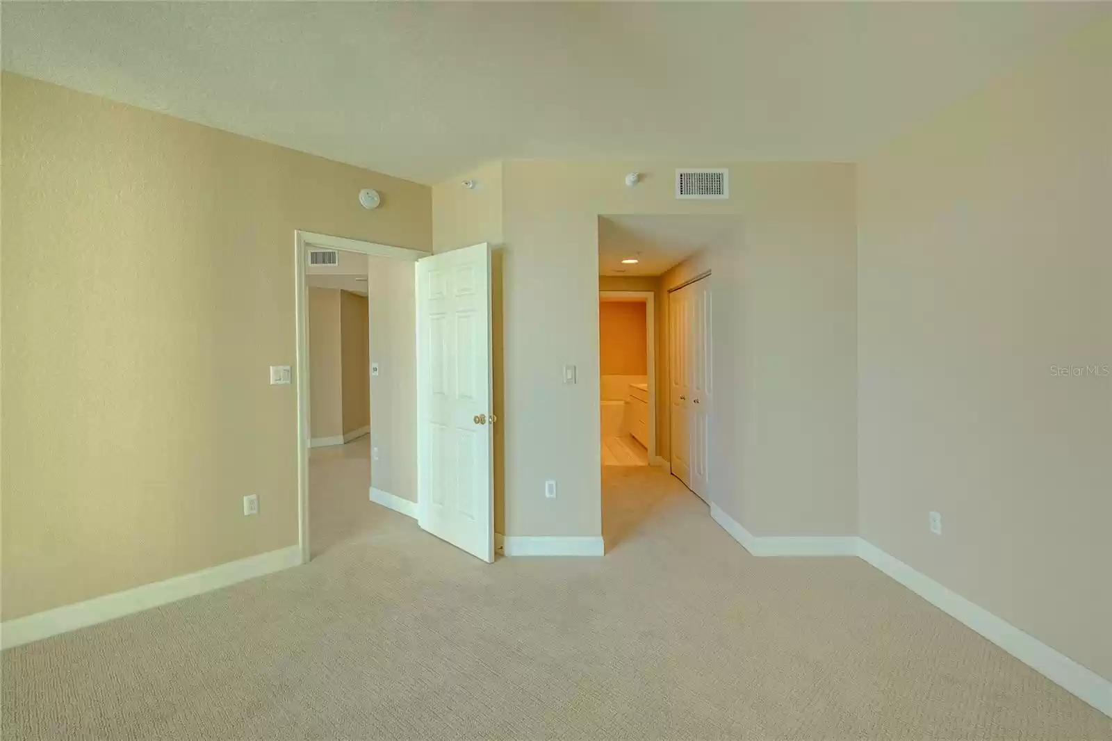 View from the master bedroom towrd the entry hall of the unit and the closet area.