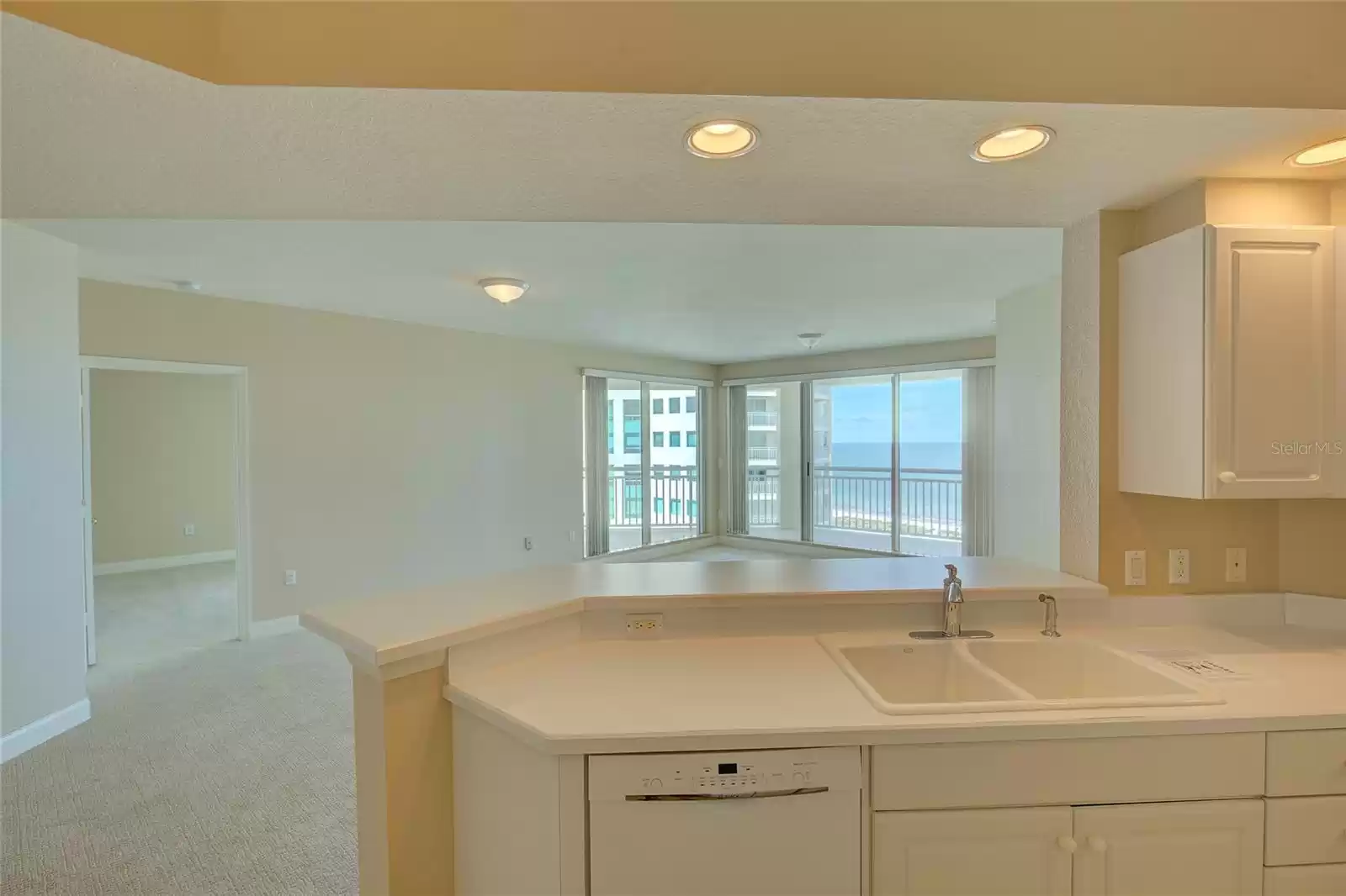 Entertain guests while you cook as they gather around the bar area. The master bedroom is on the left.