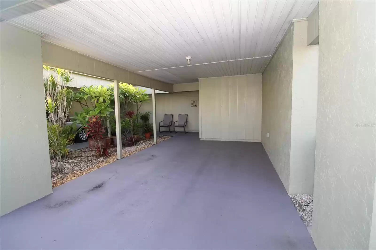 Rear, covered carport entrance situated on private cul-de-sac