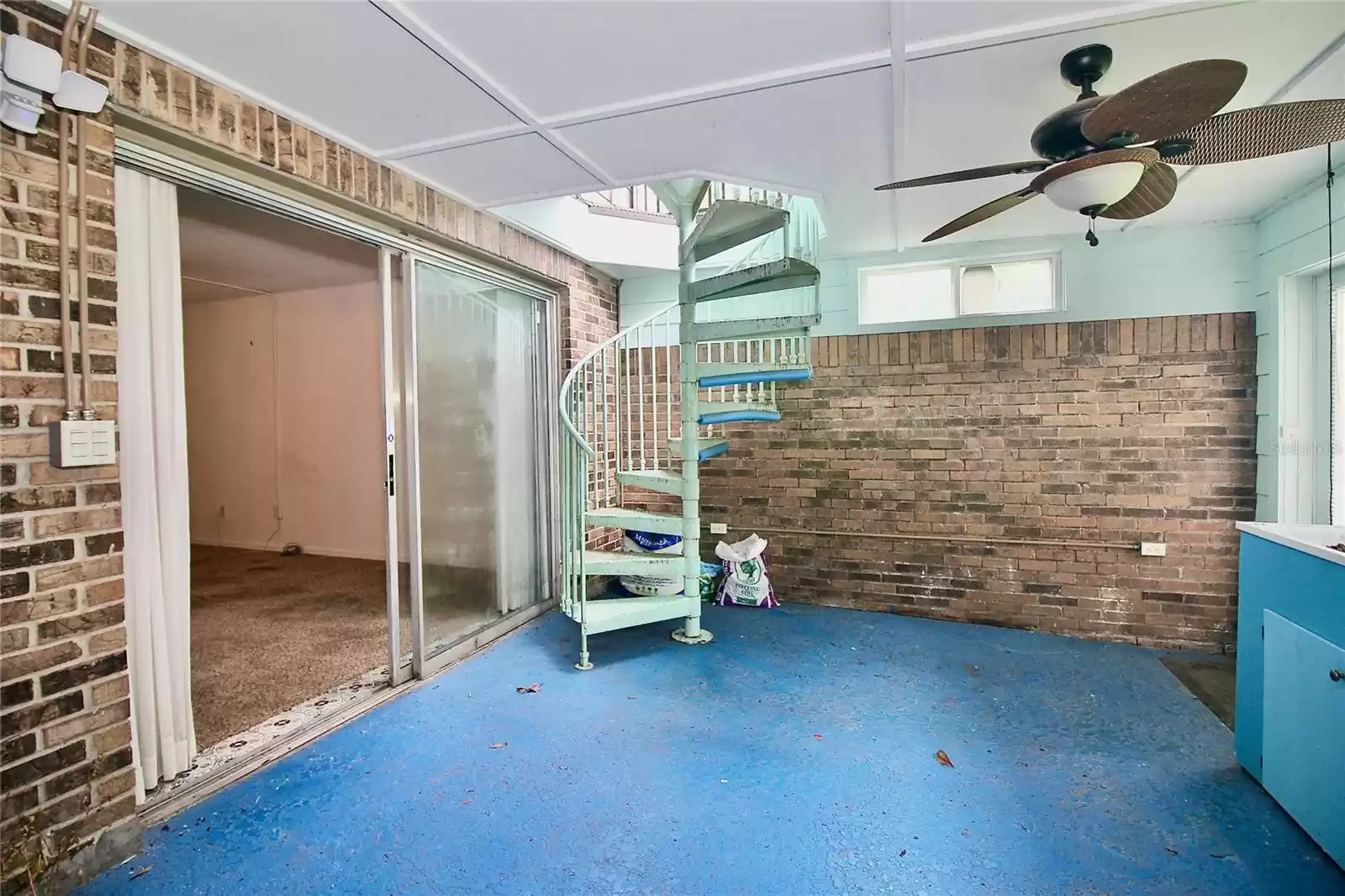 ENCLOSED PATIO WITH STAIRS TO OPEN AIR DECK