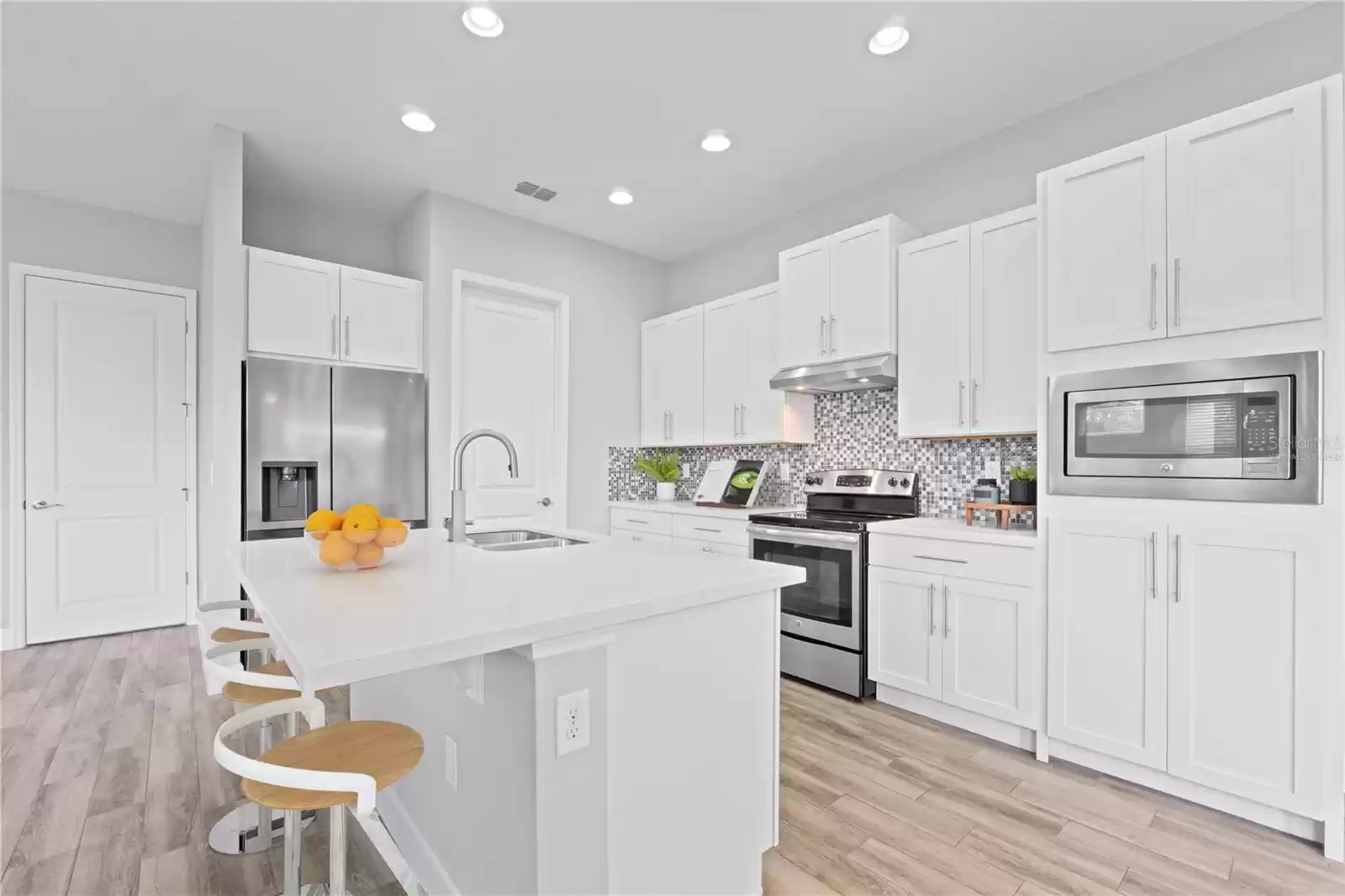 “Virtually Staged” Open Concept Kitchen with Island. Laundry Room.