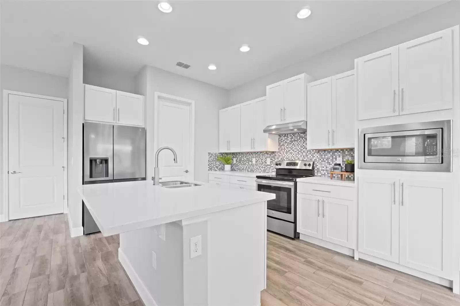 “Virtually Staged” Open Concept Kitchen with Island. Laundry Room.