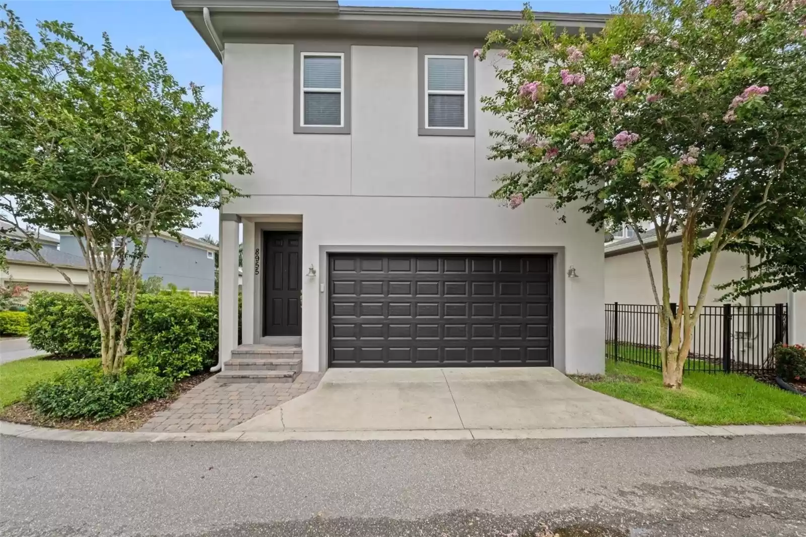 Rear Alley Facing Two Car Garage with Rear Private Above Garage Apartment Entrance.