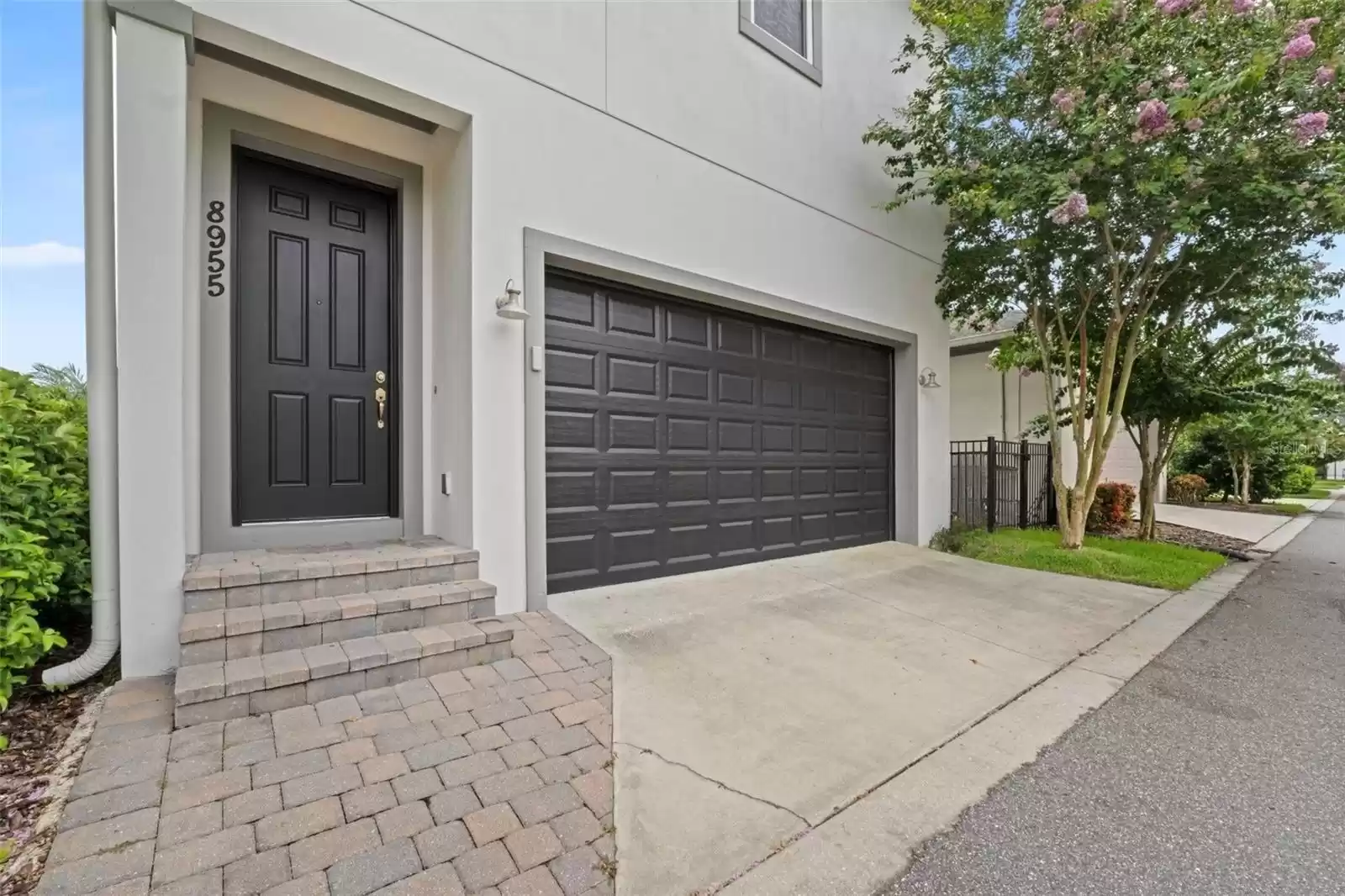 Rear Alley Facing Two Car Garage with Rear Private Above Garage Apartment Entrance.