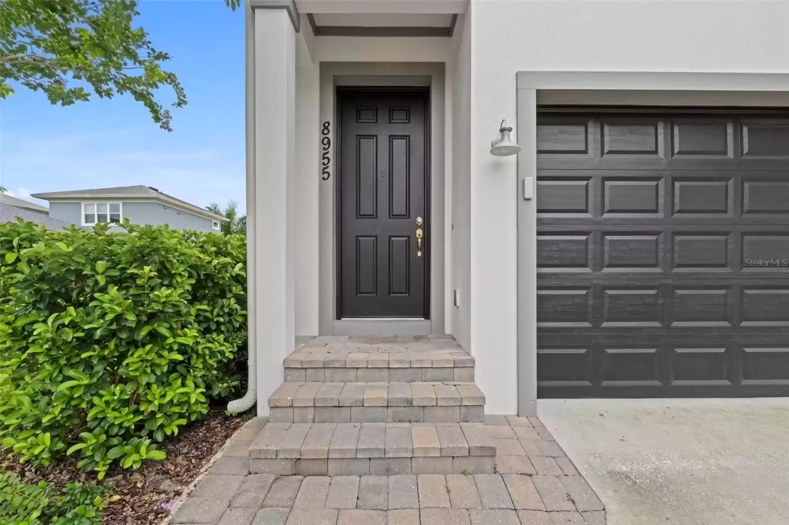 Rear Alley Facing Two Car Garage with Rear Private Above Garage Apartment Entrance.