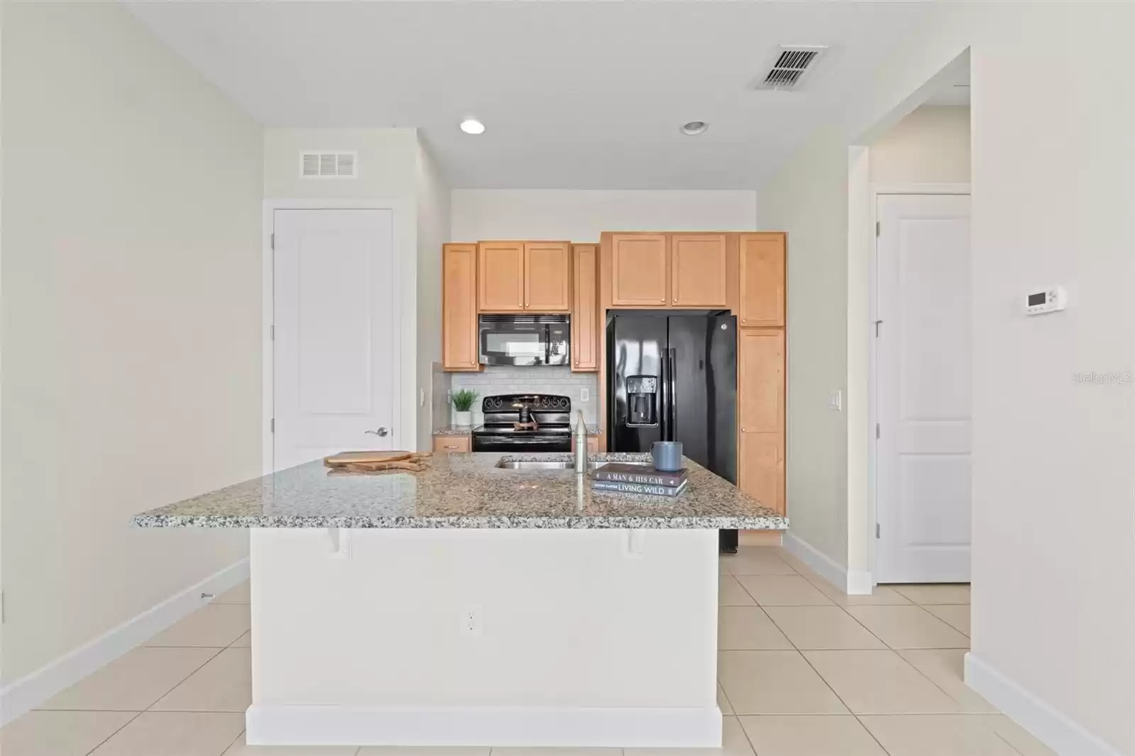 Above Garage Apartment Open Concept Kitchen with Island and Interior Laundry.