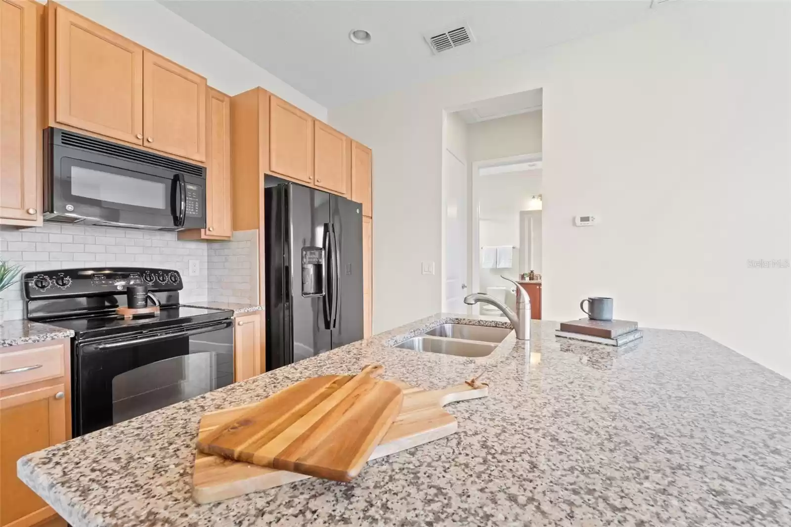 Above Garage Apartment Open Concept Kitchen with Island and Interior Laundry.