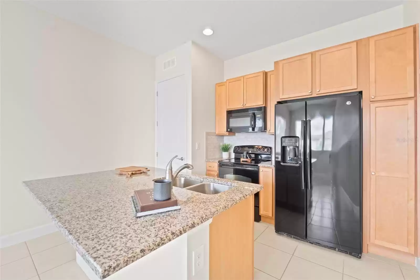 Above Garage Apartment Open Concept Kitchen with Island and Interior Laundry.