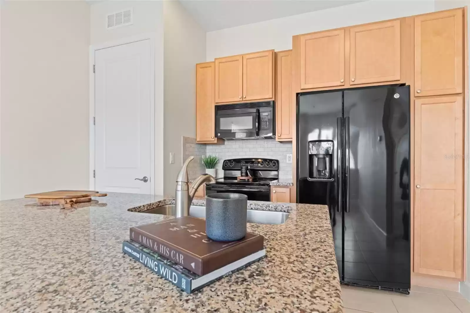 Above Garage Apartment Open Concept Kitchen with Island and Interior Laundry.