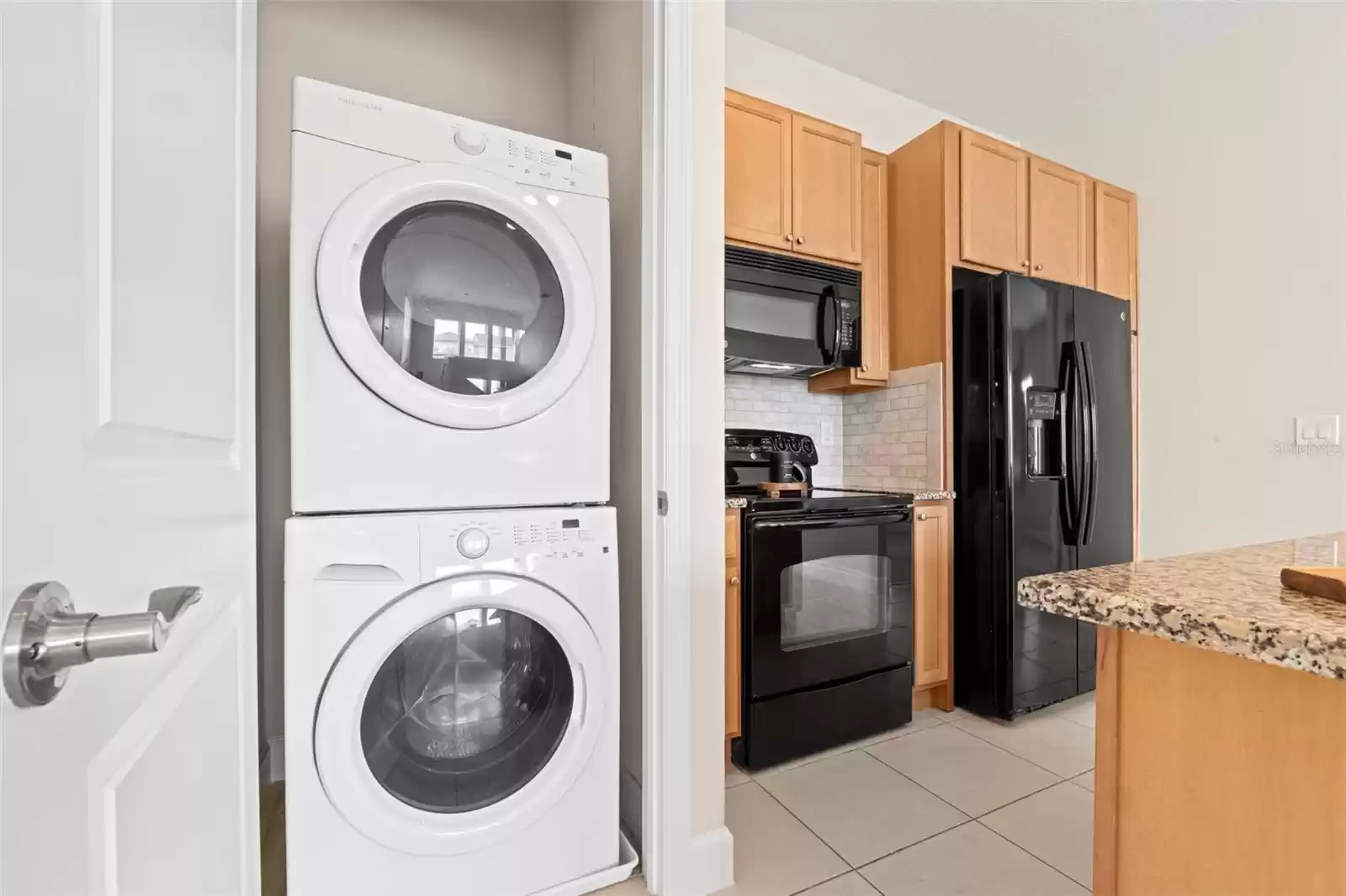 Above Garage Apartment Open Concept Kitchen with Island and Interior Laundry.