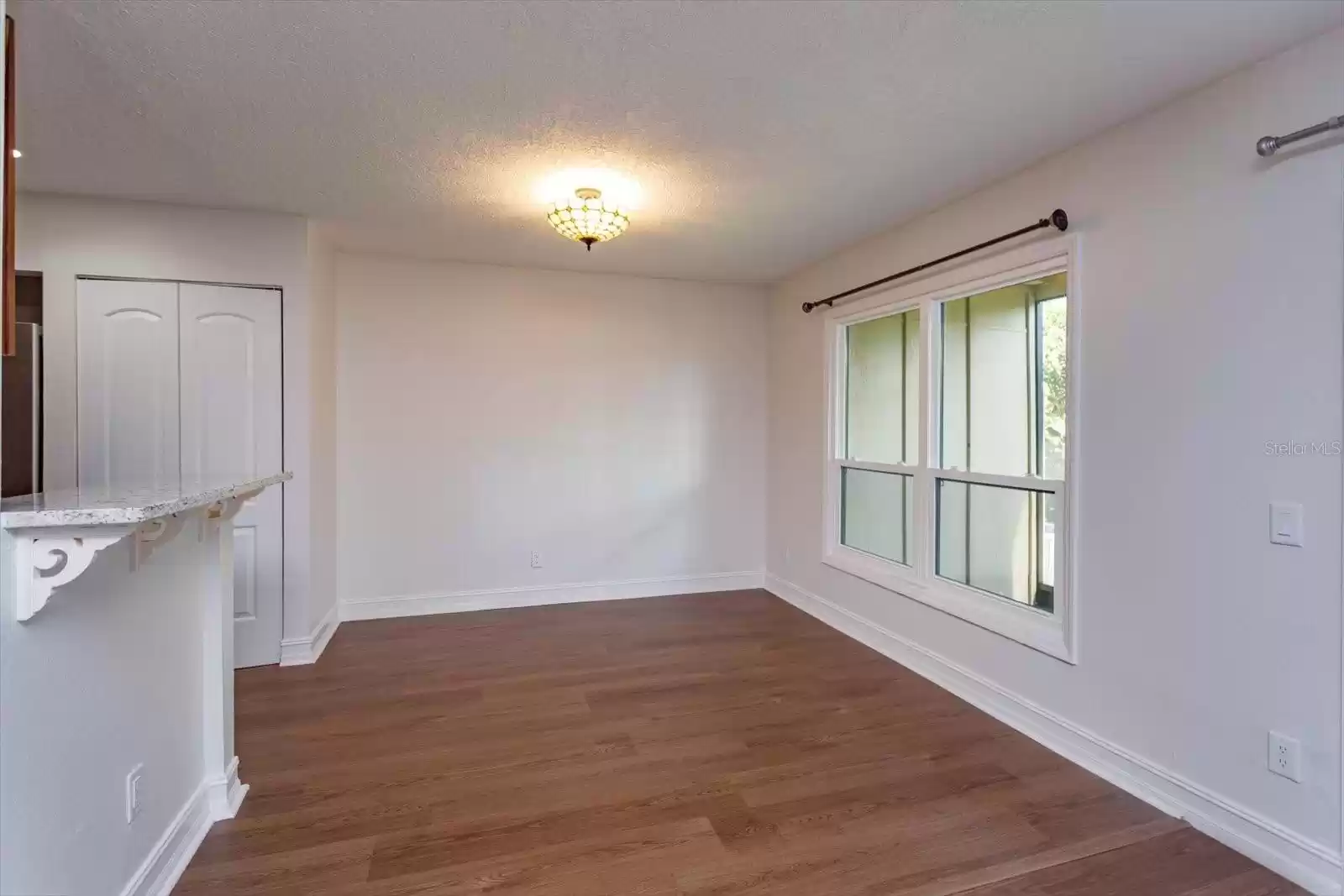 dining room with large window overlooking screened patio