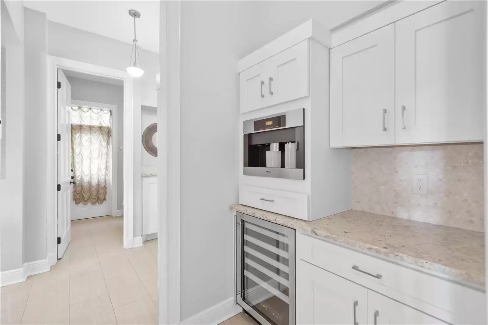 Butler's Pantry and note half bath at entry from the garage area