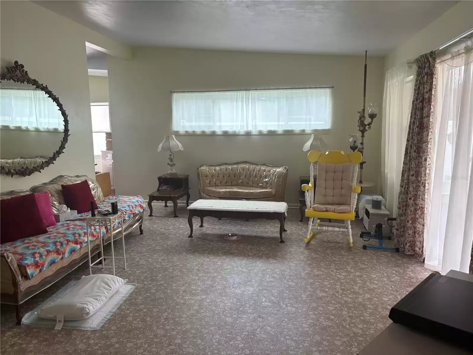 Living Room with access to the enclosed patio and backyard