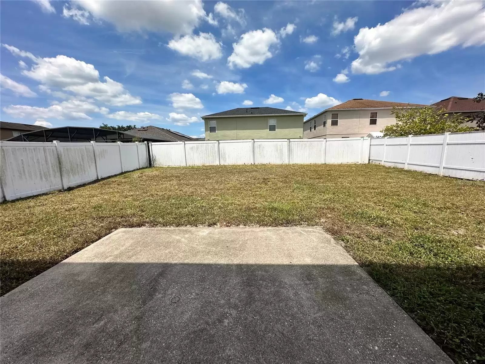 Patio opens to backyard which is fenced on 3 sides