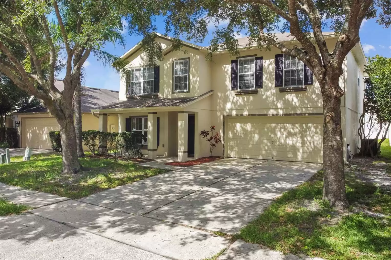 Shady front yard is framed by mature trees