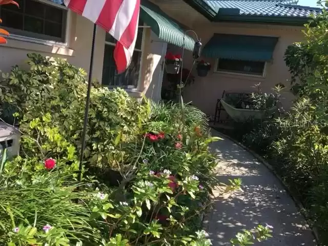 Front Entry Walk with flower garden on each side.  (Trimming has been done since photos were taken.)