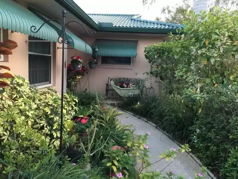 Beautiful Metal Roof to last a lifetime with matching awnings. Newer Hurricane Impact Windows.