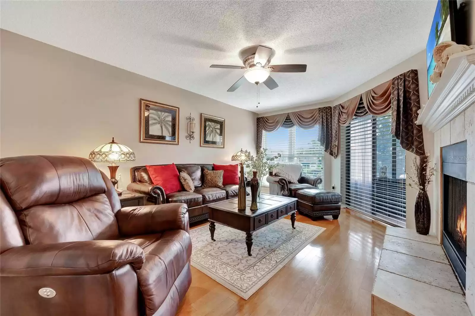 Large window and sliding door with view of porch and pool