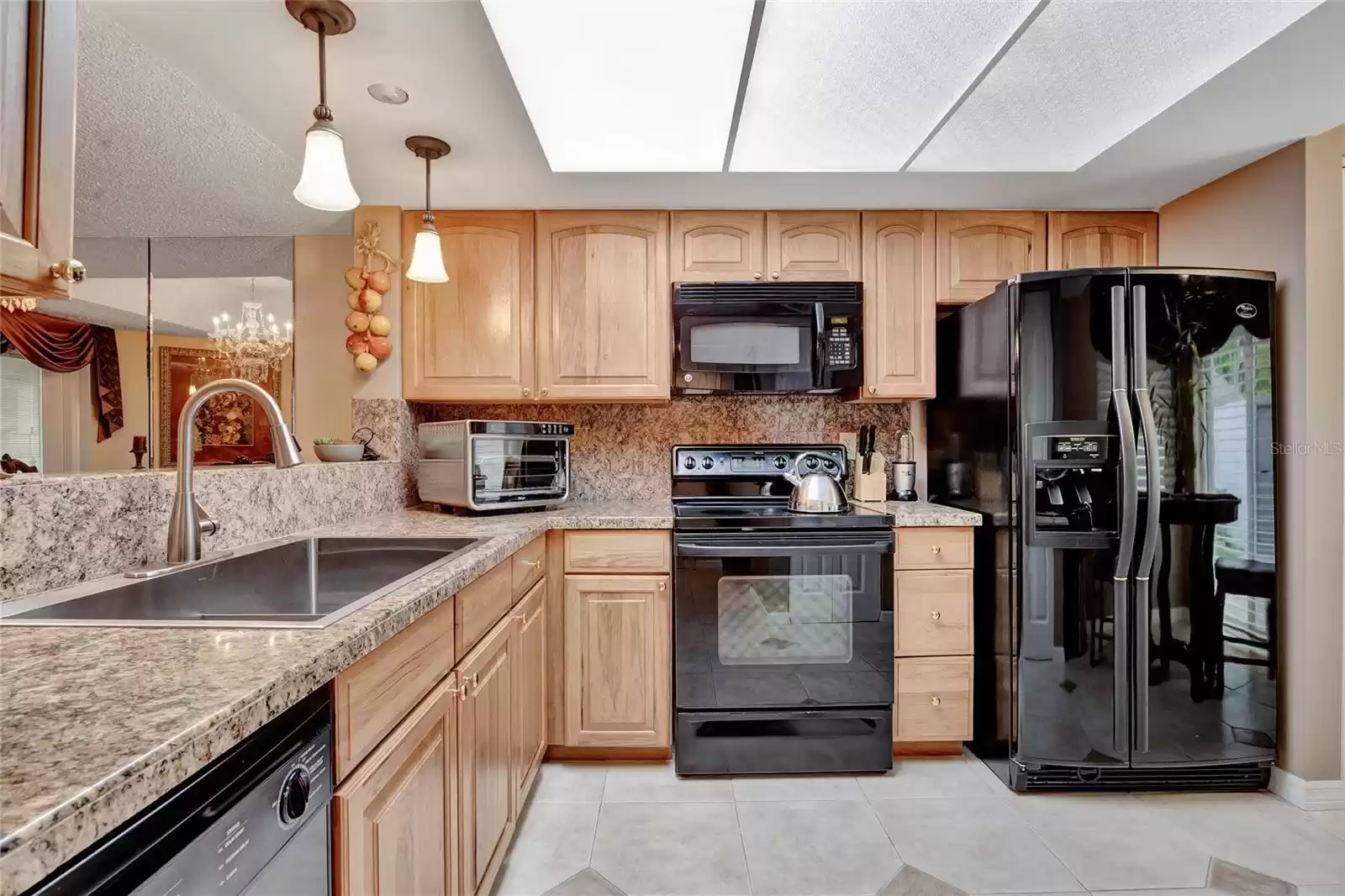 Kitchen looks into dining and living rooms