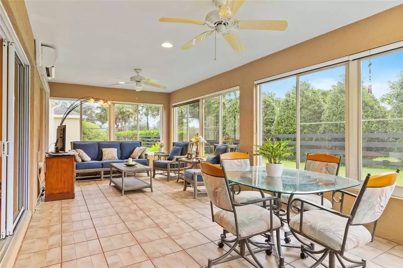 Florida living at its best! Glass enclosed lanai with screens, heat deflecting shades, and a mini-split for year round comfort.