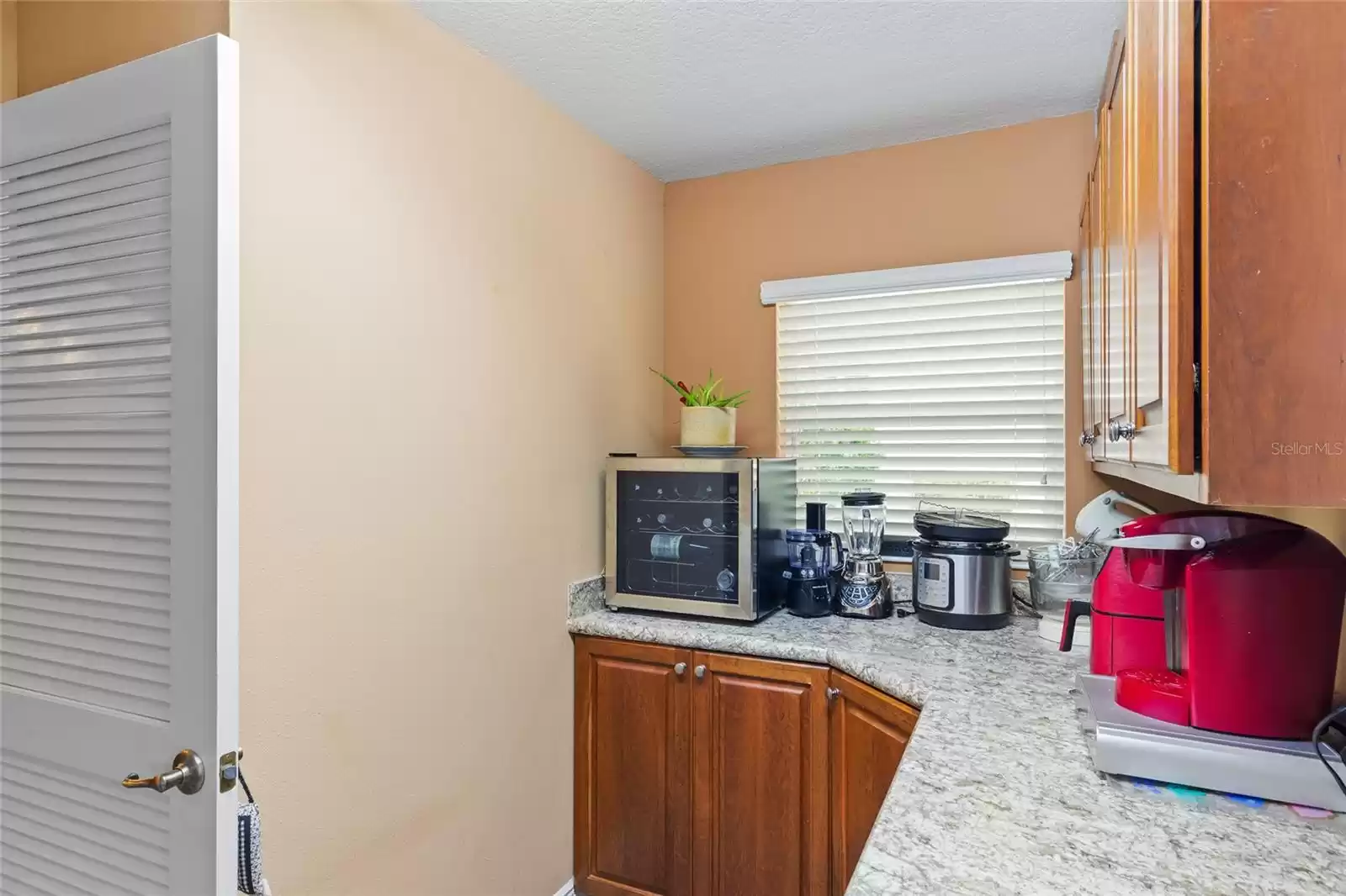 Bonus cabinets and marble countertops in the laundry room to store your extra kitchen gadgets